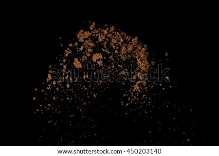 Soil explosion isolated on black background. Abstract cloud of brown ground.