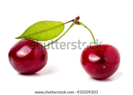Two cherries with leaf closeup isolated on white background