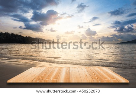 Empty top of wooden shelves and seascape of sunset background. 