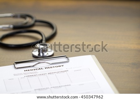 Black Stethoscope Isolated on Light Brown Wooden Desktop with Right Space
