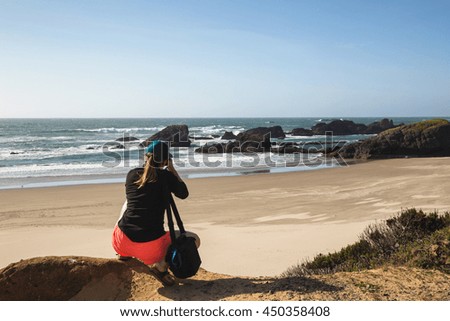 Tourist enjoying the view of the beautiful beach in Oregon Coast.