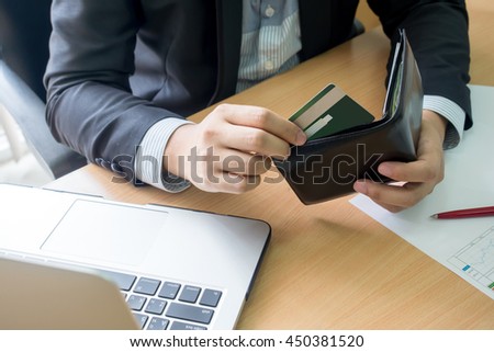 businessman bring credit card out  from wallet for shopping online Royalty-Free Stock Photo #450381520