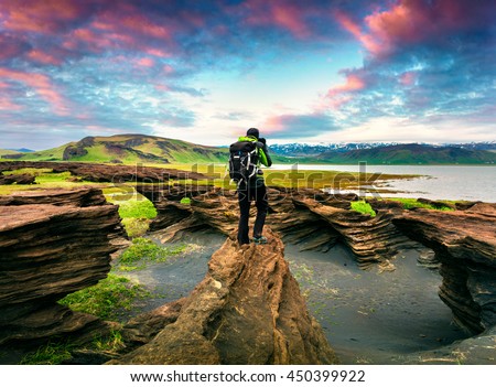 Photographer take a picture of sunset on the volcanic origin peninsula - Dyrholaey , south coast of Iceland, near Vik village, Europe. Artistic style post processed photo.