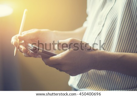 businessman working with modern devices, digital tablet computer and mobile smart phone,selective focus,vintage color Royalty-Free Stock Photo #450400696