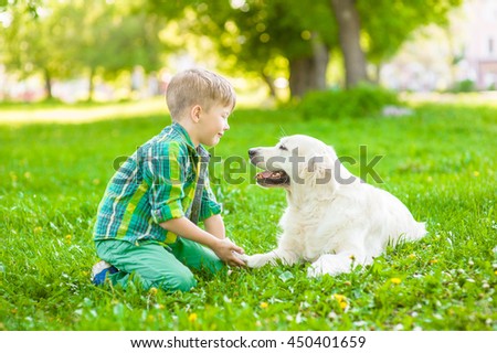 Boy with dog on green grass