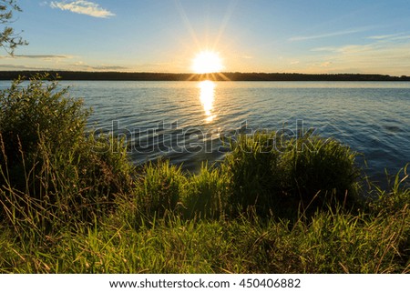 Scenic view of beautiful sunset above the lake at summer season, landscape