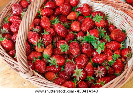 Big strawberry in wooden basket. Top view, high resolution product.