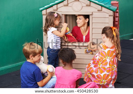 Group of children watching puppet theater play in a kindergarten