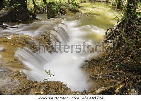 Little waterfall in forest,select focus with shallow depth of field:ideal use for background.