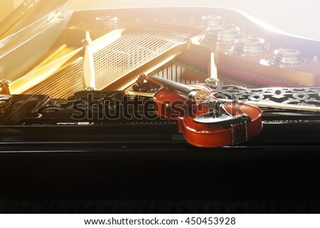 Violin lying on piano, close up