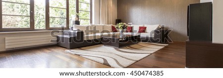 Warm living room in new style with large sofa and small table