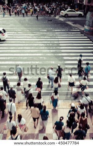 Asian People are across the crosswalk