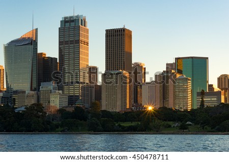 Sydney CBD skyscrapers on sunset with sun reflecting from windows. Modern  urban cityscape with office buildings