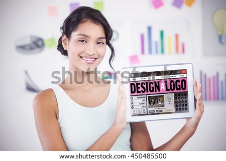 Happy businesswoman showing digital tablet in creative office against webpage for create a logo