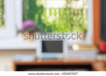 Abstract office desk table with computer, supplies, flower blur background. Copy space for text.
