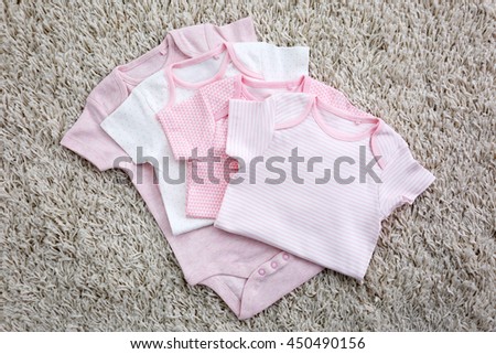 Baby clothes on light background