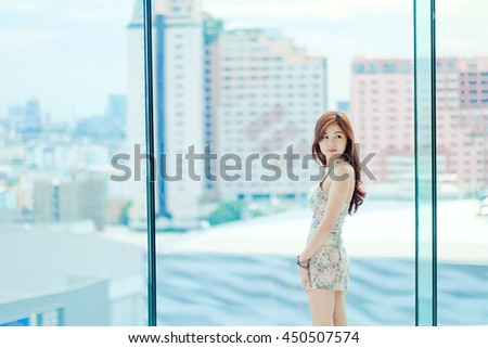 Cute girl standing on a bright day . Brown hair sparkling red