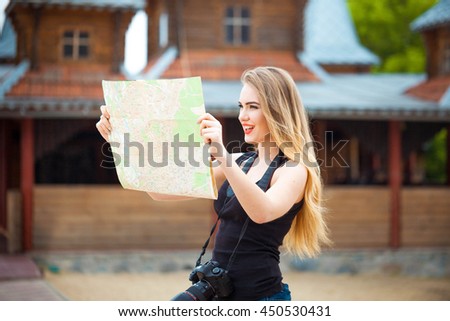 Young woman traveling in country by weekend. searching road on the map. looking place for photo