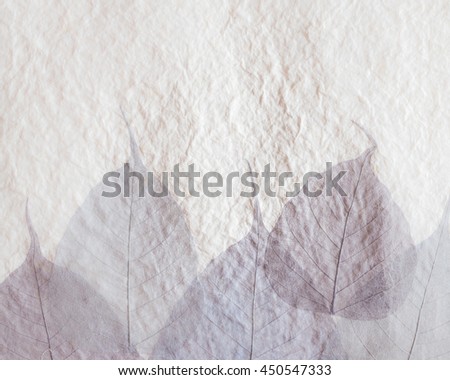 Old craft recycled light brown white mulberry paper texture background with dried leaves texture decorated. Royalty-Free Stock Photo #450547333