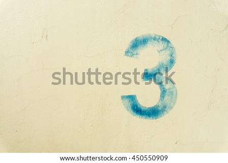 the number 3 on the dirty  wall