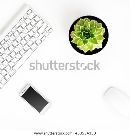 White office desk table with wireless aluminum keyboard, smart phone in iphon style with black screen, mouse and succulent flower in pot. Top view with copy space. Flat lay. 
 Royalty-Free Stock Photo #450554350