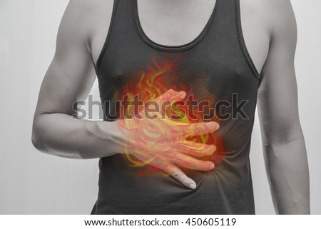 Man's hearts - the stomach - visceral painful.Concept photo with Color Enhanced pale skin with Fire indicating location of the pain.
