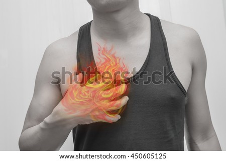 Man's hearts - the stomach - visceral painful.Concept photo with Color Enhanced pale skin with Fire indicating location of the pain.
