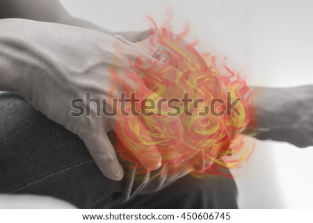 Man knee and leg painful.Concept photo with Color Enhanced pale skin with Fire indicating location of the pain.
