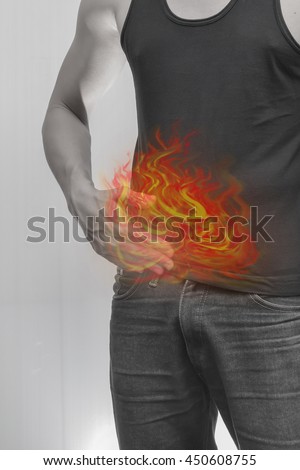 Man kidney, liver, intestine, stomach, bladder painful.Concept photo with Color Enhanced pale skin with Fire indicating location of the pain.
