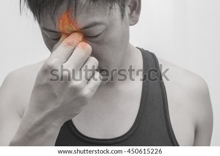 Man sinus painful.Concept photo with Color Enhanced pale skin with Fire indicating location of the pain.
