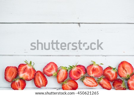strawberry border pattern on a white wooden background
