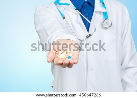 Doctor giving you a pill Royalty-Free Stock Photo #450647266