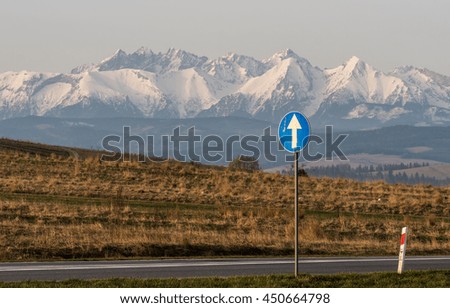 Morning view of the Tatra mountains and proceed straight traffic sign