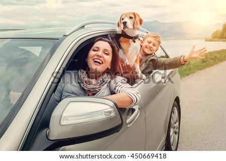 Happy family look out from car windows Royalty-Free Stock Photo #450669418