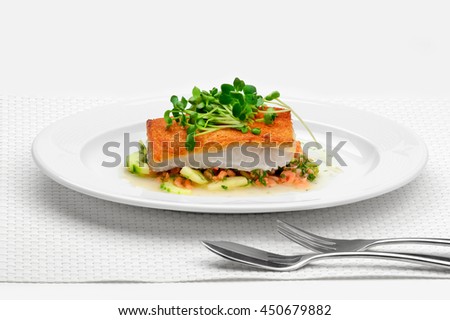 Crispy white fish with a crust of bread and a sauce of small shrimp and cucumber