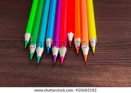 bright colored pencils on the wooden table