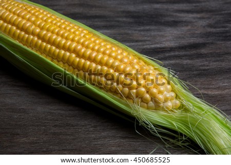 Ripe corn on a background of old wood