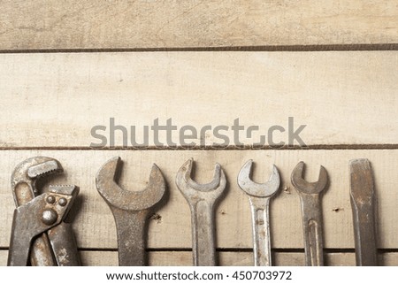 Set of construction tools. Wrench on wooden background.