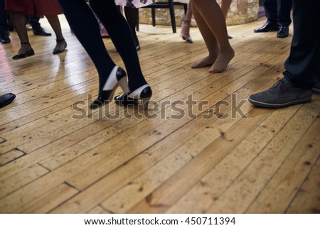 Picture of people's legs while they whirl on the dancefloor
