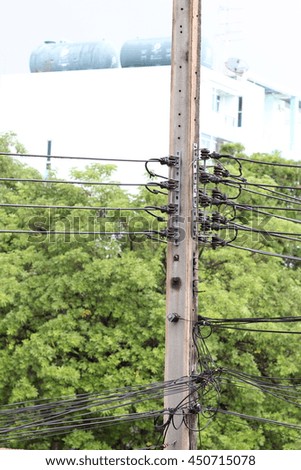 Electric pole connect to the high voltage electric wires on green natural  background.