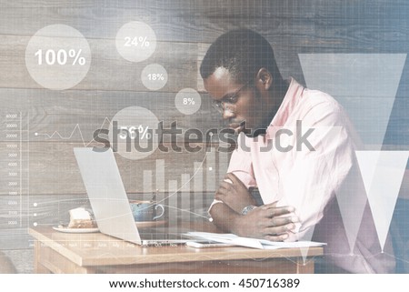 Graphic icons, double exposure. Young African American accounting clerk making an annual financial report, drawing diagrams, looking at laptop screen with thoughtful and serious face expression