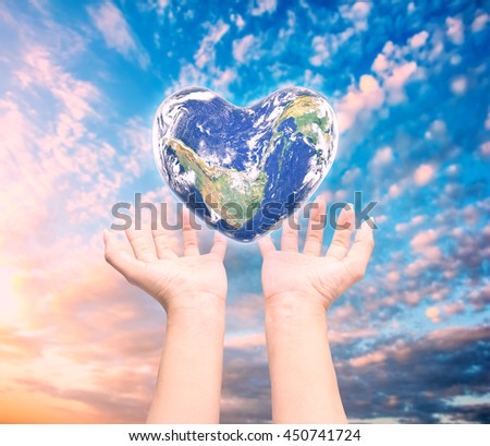 World in heart shape with over women human hands on blurred natural background: World Heart health day,Element of this image furnished by NASA