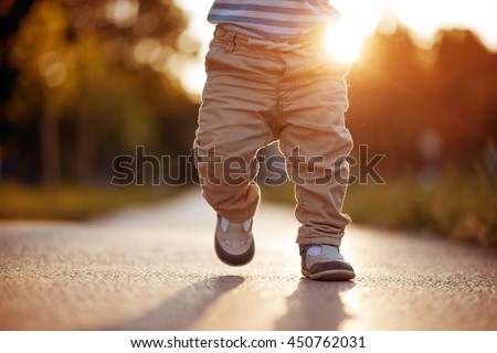 Baby's first steps.The first independent steps. Royalty-Free Stock Photo #450762031