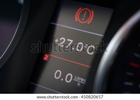 Image of a car's dashboard displaying parking light alert icon.