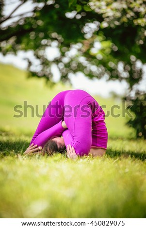 Beautiful young woman doing yoga in the summer park. Healthy lifestyle. Yoga.