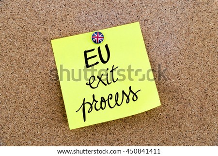 Yellow paper note pinned on cork board with Great Britain flag thumbtack, written text EU Exit Process, United Kingdom exit from European Union concept