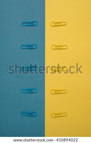 Close-up of blue and yellow paper clips