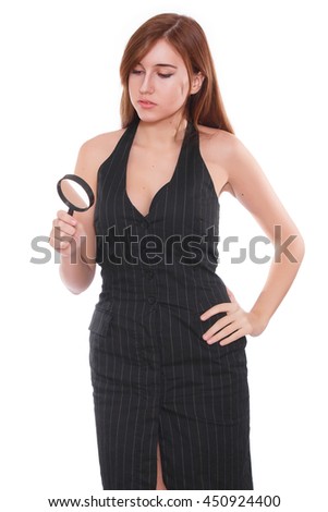 Young attractive smiling business woman using a magnifying glass, isolated on white background