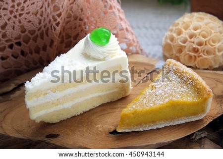Coconut cake with pumpkin pie on the table