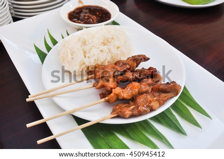 Grilled pork and sticky rice of thai .